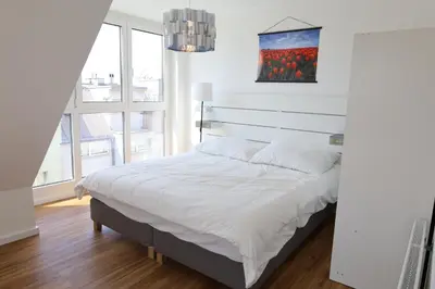 Ein Bett oder Betten in einem Zimmer der Unterkunft Penthouse Apartments
