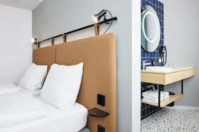 Ein Bett oder Betten in einem Zimmer der Unterkunft H2 Hotel Wien Schönbrunn
