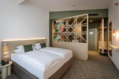 Ein Bett oder Betten in einem Zimmer der Unterkunft ARCOTEL AQ Wien