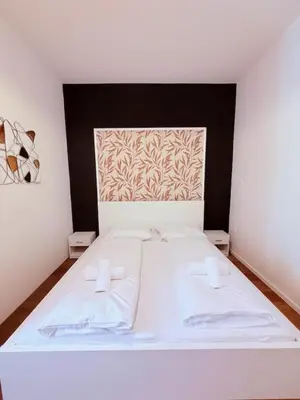 Ein Bett oder Betten in einem Zimmer der Unterkunft Apartments Maximilian