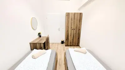 Ein Bett oder Betten in einem Zimmer der Unterkunft Spacious Rooms - 15 Min from Airport & City Center, 5 Min from Vienna Main-Bus Station EZ1