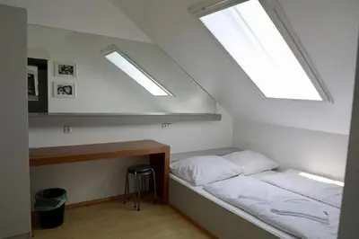 Ein Bett oder Betten in einem Zimmer der Unterkunft Storchencamp Gästehaus Purbach