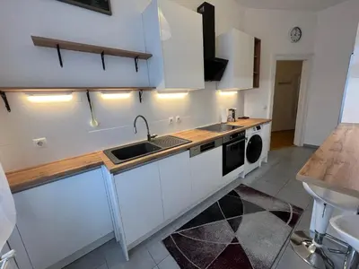 Küche/Küchenzeile in der Unterkunft A stylish and comfortable 2 bedroom apartment with thoughtful design, private balcony, and a relaxing bathtub, making it perfect for well being and cozy city living