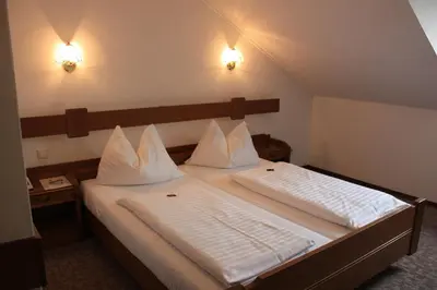 Ein Bett oder Betten in einem Zimmer der Unterkunft Burgenländerhof Hotel Garni