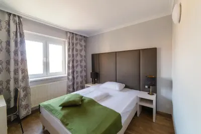 Ein Bett oder Betten in einem Zimmer der Unterkunft Arion Airport Hotel
