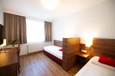 Ein Bett oder Betten in einem Zimmer der Unterkunft KSV Hotel Wien