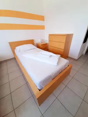 Ein Bett oder Betten in einem Zimmer der Unterkunft Lenas West Hotel