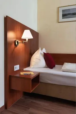 Ein Bett oder Betten in einem Zimmer der Unterkunft Hotel Mozart