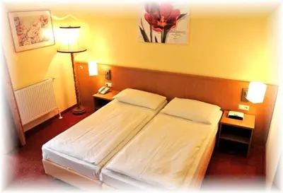 Ein Bett oder Betten in einem Zimmer der Unterkunft Parkhotel Neubauer