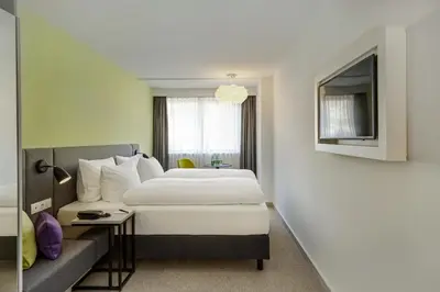 Ein Bett oder Betten in einem Zimmer der Unterkunft H+ Hotel Wien