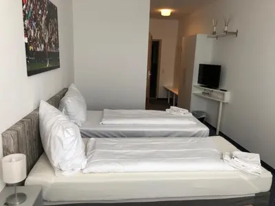 Ein Bett oder Betten in einem Zimmer der Unterkunft Pension Tennisweber