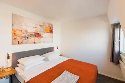 Ein Bett oder Betten in einem Zimmer der Unterkunft URBAN ISLAND I Riverside Apartments