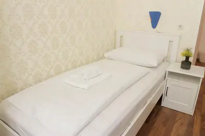 Ein Bett oder Betten in einem Zimmer der Unterkunft Hotel Pension ARPI