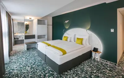 Ein Bett oder Betten in einem Zimmer der Unterkunft ARCOTEL Donauzentrum Wien