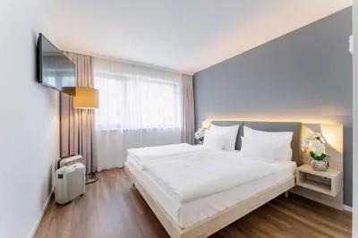 Ein Bett oder Betten in einem Zimmer der Unterkunft PLAZA INN Wien Gasometer