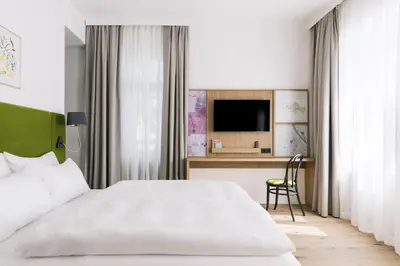 Ein Bett oder Betten in einem Zimmer der Unterkunft Bio-Hotel Schani Wienblick