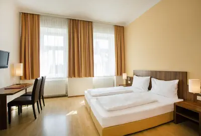 Ein Bett oder Betten in einem Zimmer der Unterkunft Hahn Hotel Vienna