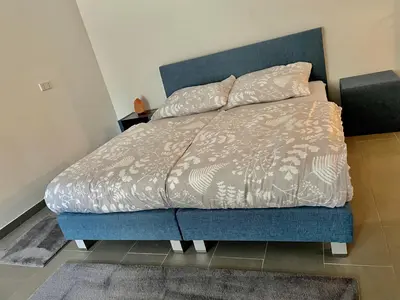 Ein Bett oder Betten in einem Zimmer der Unterkunft Sandy’s Home