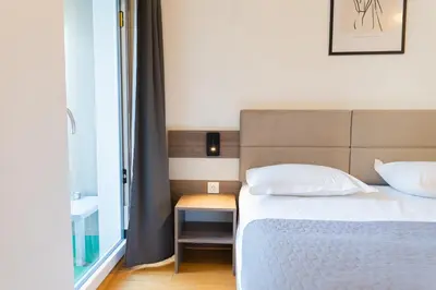 Ein Bett oder Betten in einem Zimmer der Unterkunft Hotel Triester
