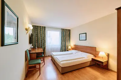 Ein Bett oder Betten in einem Zimmer der Unterkunft Hotel Deutschmeister